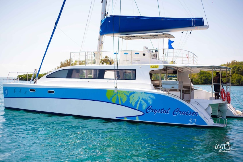 A Crystal Cruiser yacht with a blue and white color scheme, number 52, docked at a marina. 4