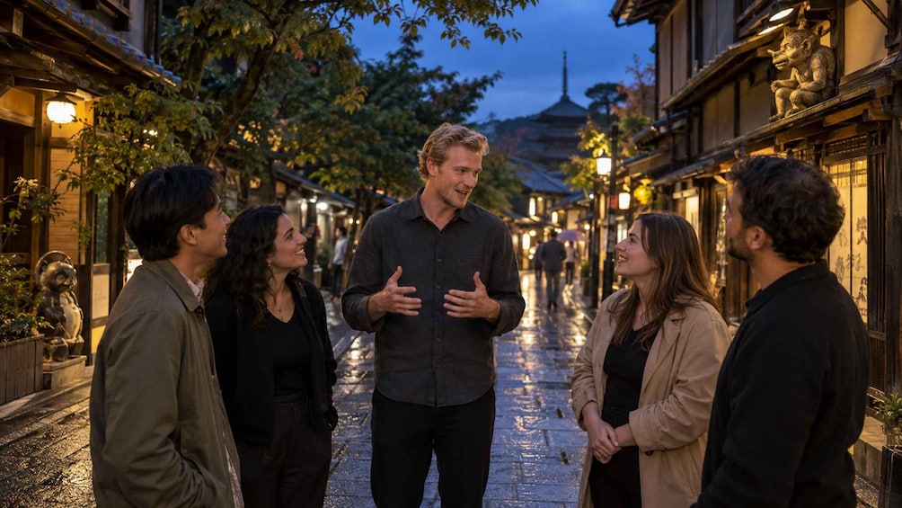 A group of people standing on a wet street in a traditional Asian setting with lanterns and pagoda-style buildings. 3