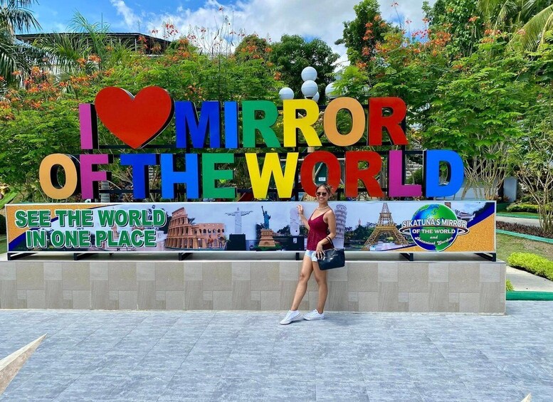 A sign with 'I ♥ MIRROR OF THE WORLD' and 'SEE THE WORLD IN ONE PLACE' along with a statue of the Eiffel Tower. 5