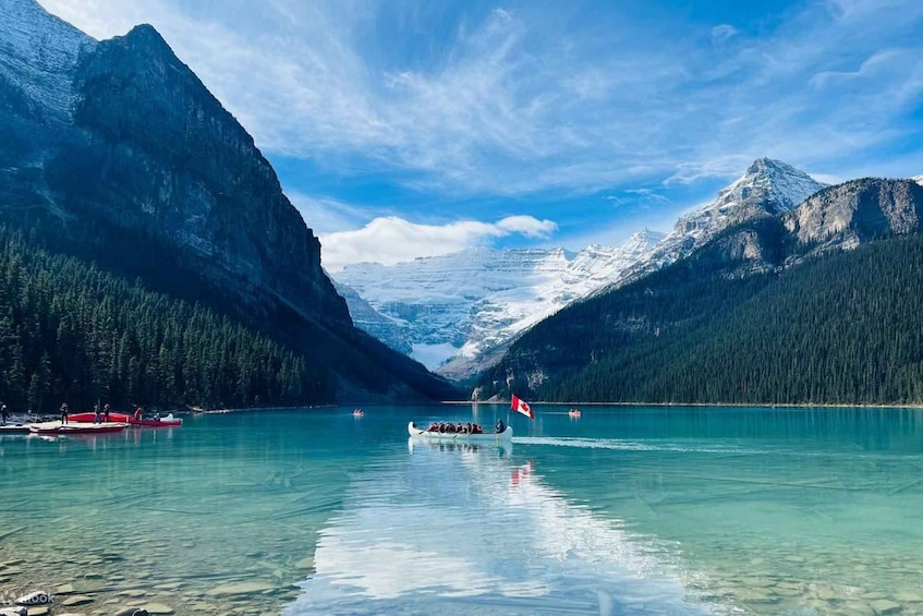 A boat on a calm lake surrounded by mountains and forests. 2