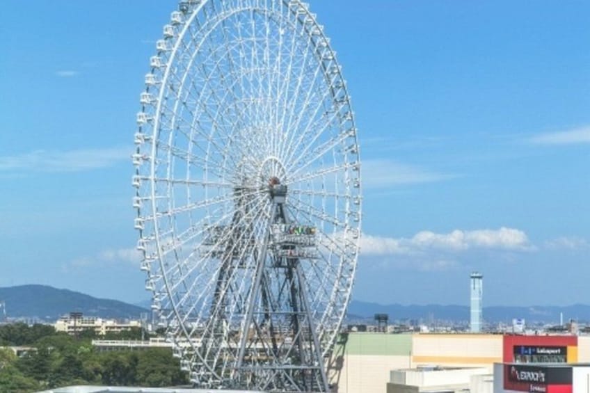 A large Ferris wheel with a clear sky in the background. 2