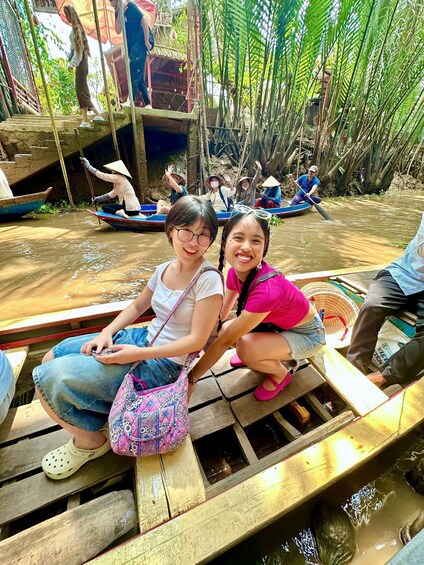 People on a boat in a river surrounded by trees. 2