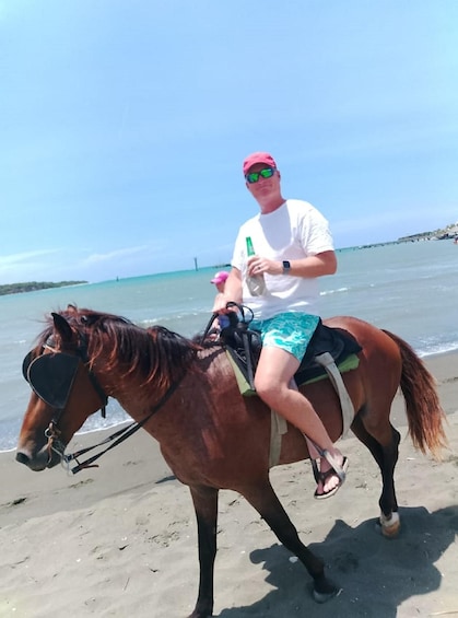 A person riding a horse on a beach. 5
