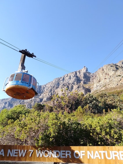 A cable car with 'Corona Extra' branding, a mountainous landscape, and a sign reading 'A NEW 7 WONDER OF NATURE.' 5