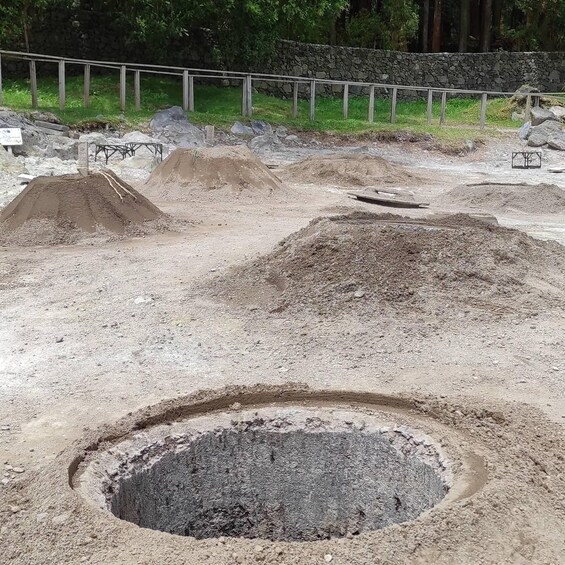 A construction site with piles of dirt and a large excavation pit. 2
