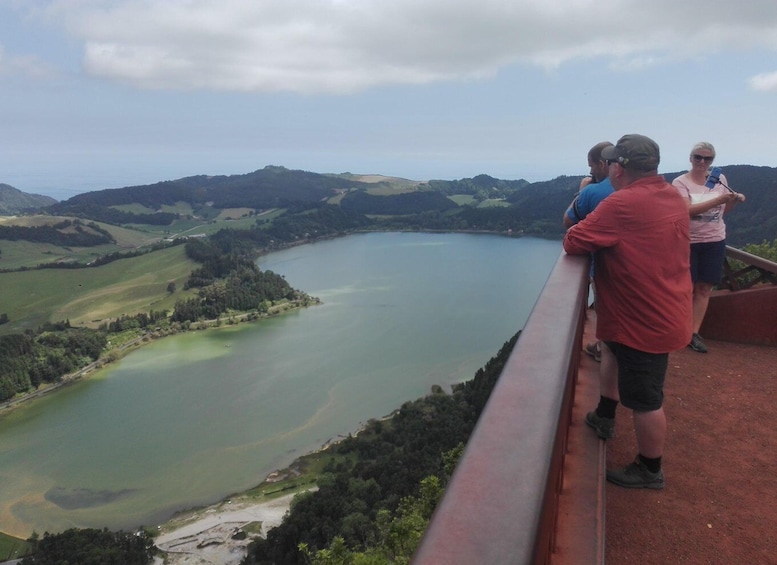 A group of people overlooking a lake surrounded by hills. 4