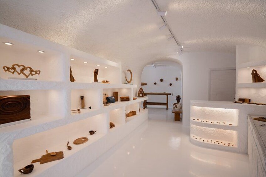 A modern interior with white walls, shelves displaying various objects, and a central seating area. 3