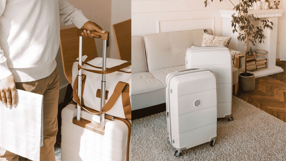 A person with a suitcase and a rolling suitcase in a living room. 2