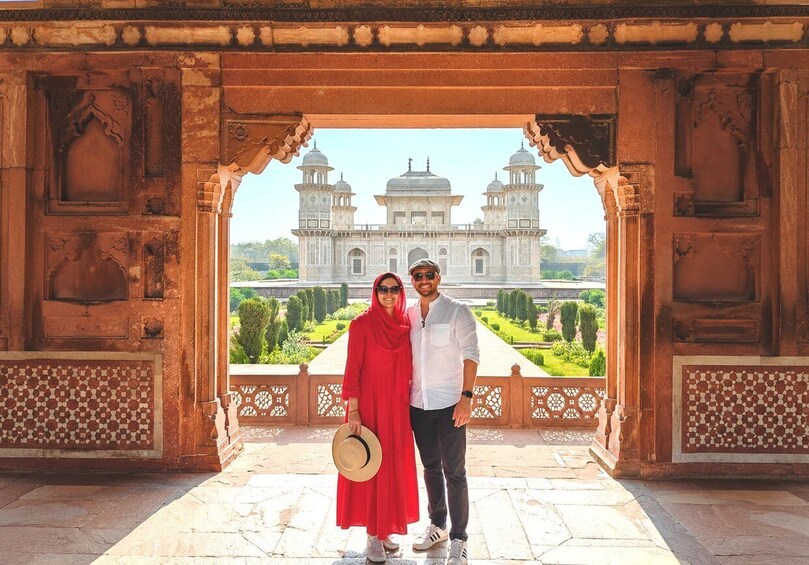 A couple standing in front of a historic building with intricate architecture. 5