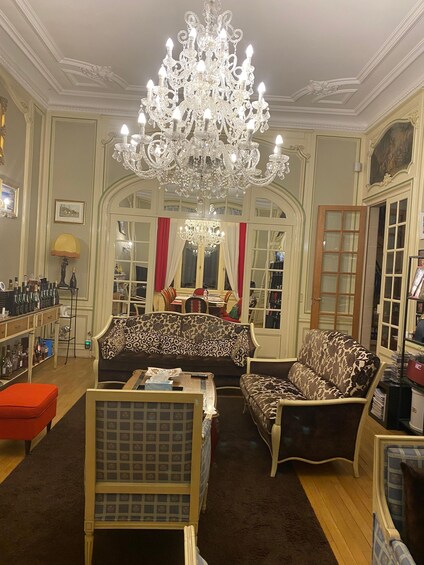 A luxurious living room with ornate furniture, a grand chandelier, and a classic design. 5