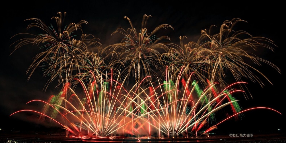 A night sky with multiple fireworks displays. 3