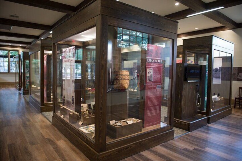 Une exposition de musée présentant des objets dans des vitrines et des panneaux d’information. 4