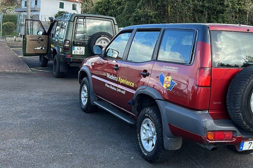 A red SUV with 'Madeira Xperience' branding parked on a street. 4