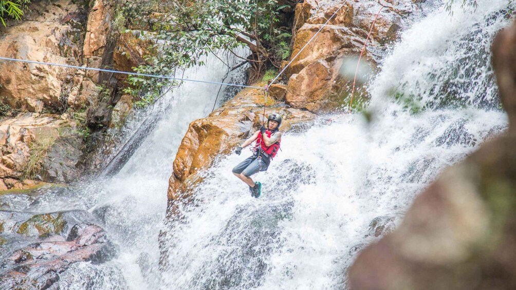 A person rappelling down a waterfall. 5