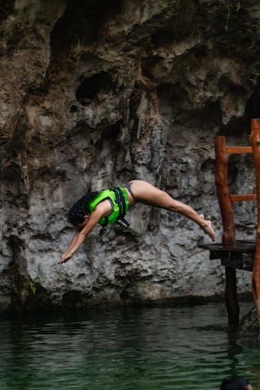 A person diving into water from a wooden platform. 5