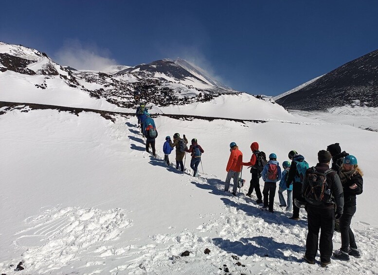 A group of hikers on a snowy mountain trail. 4