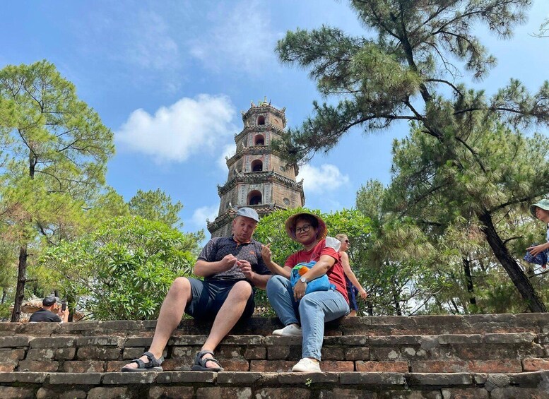 A historic tower with a clock, surrounded by trees. 4