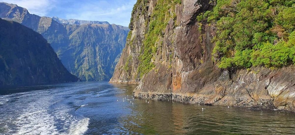 A river flowing through a canyon with steep cliffs and sparse vegetation. 2