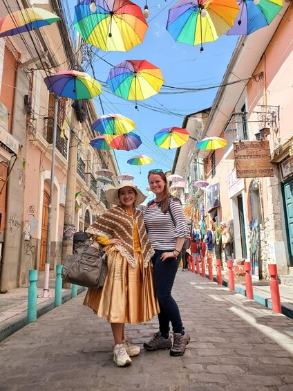 A street with colorful umbrellas and a woman in a hat and dress. 2