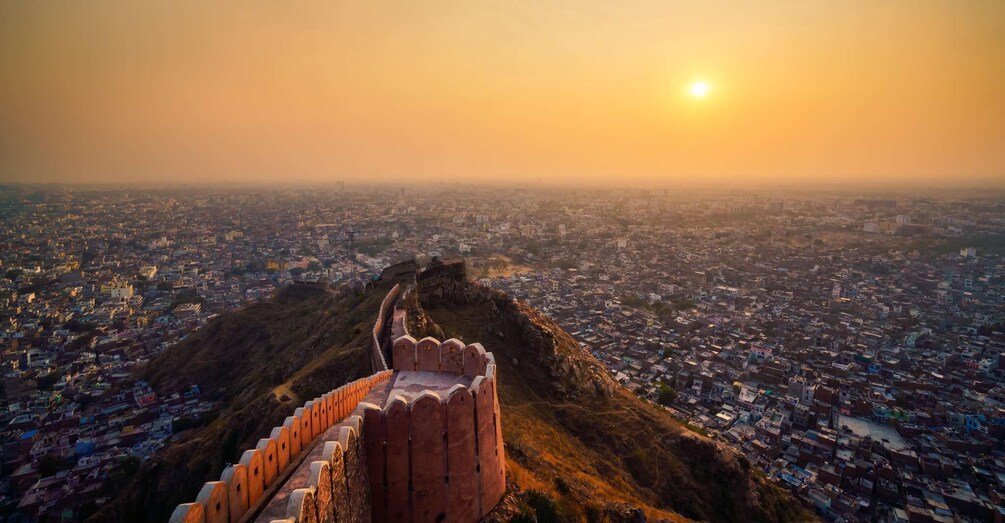 A fort overlooking a city at sunset. 3