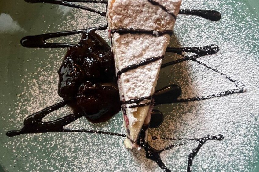A dessert with chocolate sauce and powdered sugar. 3