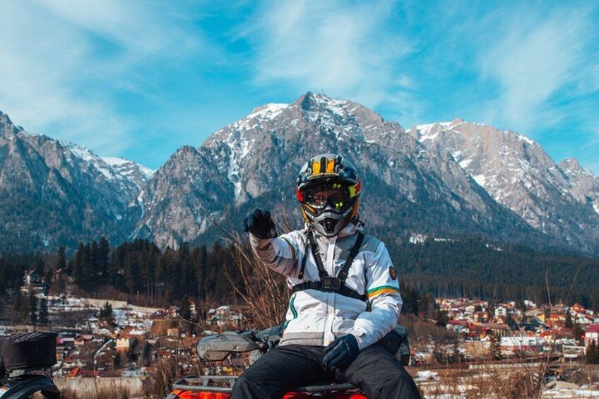 A person on a motorcycle with a mountainous landscape in the background. 2
