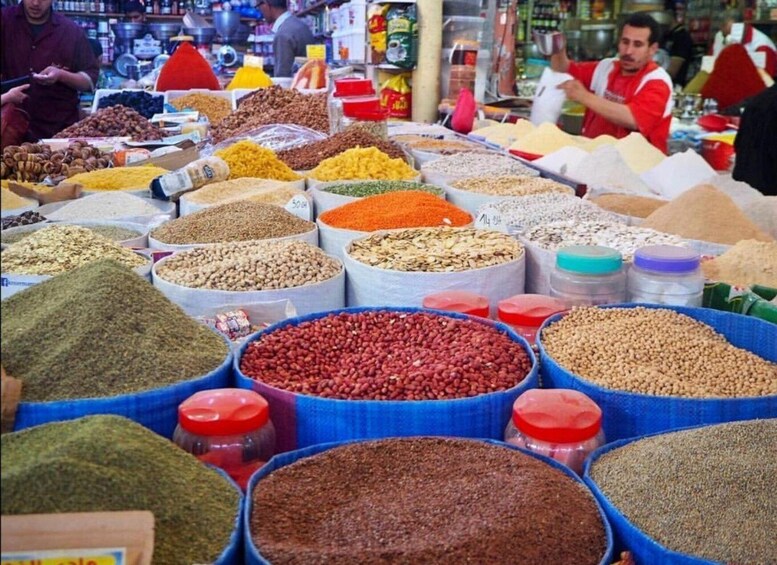 A market with various spices and grains displayed in large containers. 1