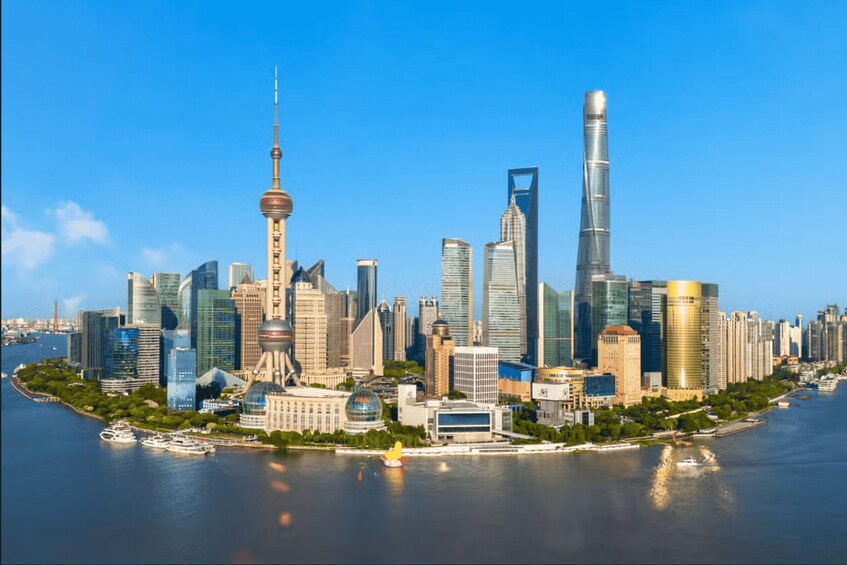 A city skyline with modern skyscrapers, a distinctive tower, and a river. 3