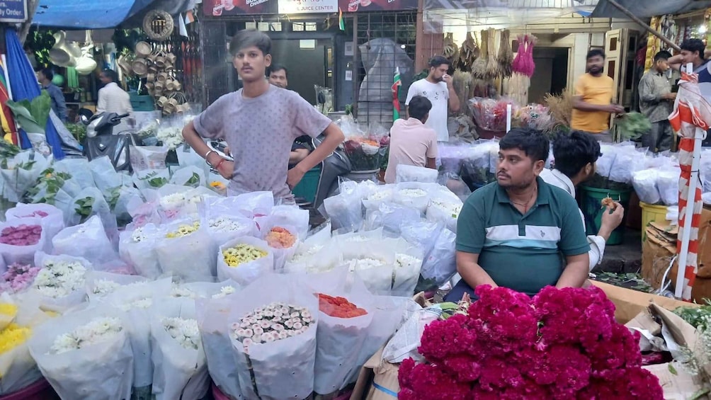 A flower market with various flowers in bags and bunches. 3