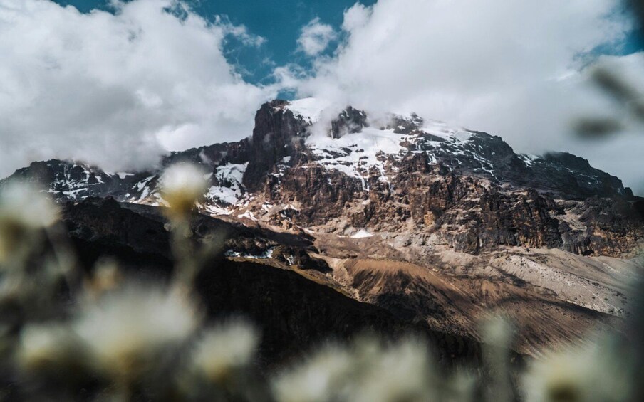 A mountain with snow-capped peaks and a rocky foreground. 3