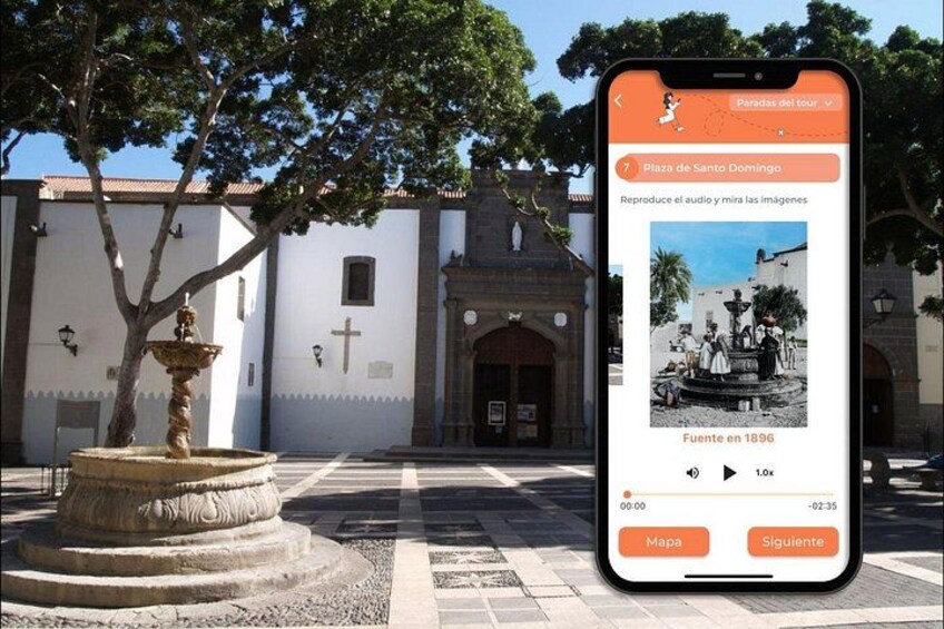 A historic plaza with a fountain, a church, and a smartphone displaying a tour guide app. 5