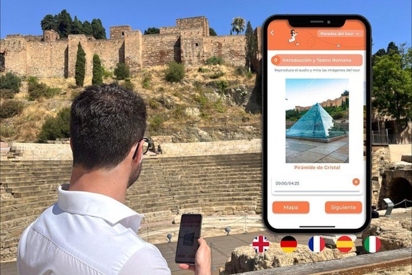 A person taking a photo with a smartphone of a historical site with ruins and a modern glass structure. 1