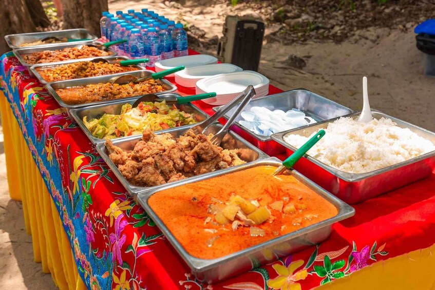 A buffet table with various dishes and drinks. 2