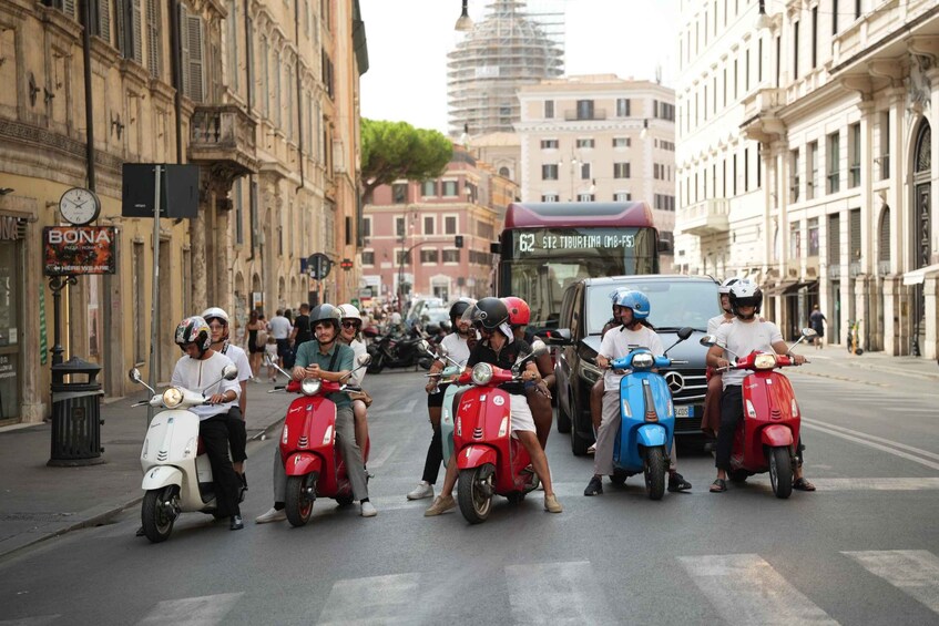A street with vintage scooters, a bus, and historic buildings. 1
