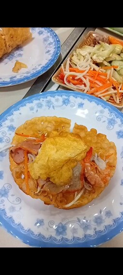 A plate with a fried egg, shrimp, and vegetables. 2