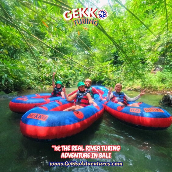 Three people rafting on a river surrounded by dense green foliage. 2