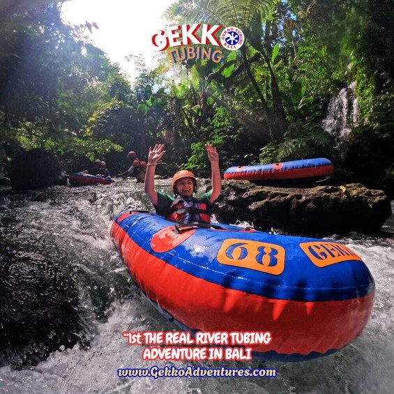 A person rafting down a river surrounded by lush greenery. 4