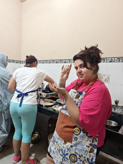 A person in a kitchen preparing food. 1
