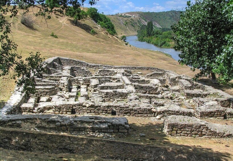 Ancient stone ruins with a river in the background. 3