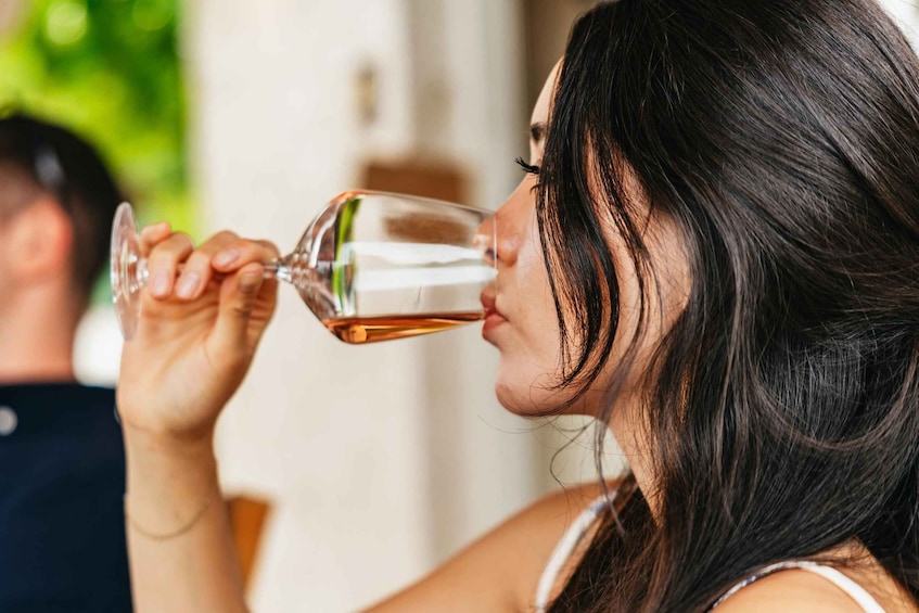 A person holding a wine glass. 2