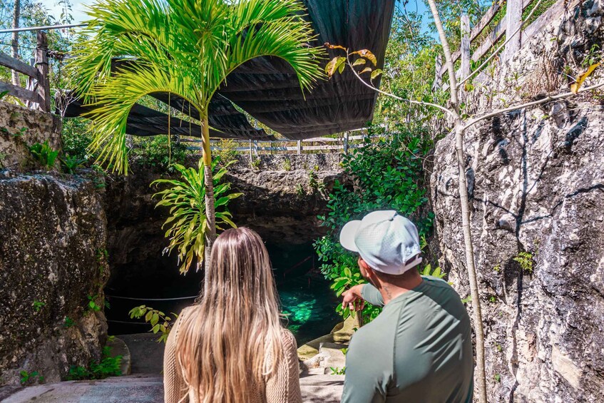 A man and a woman looking into a cave. 2