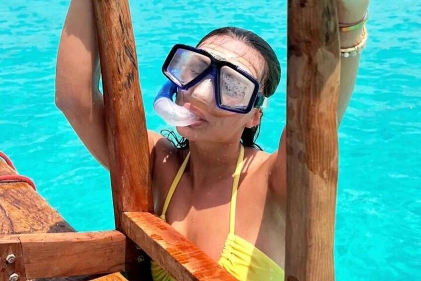A person snorkeling in a clear blue pool. 2