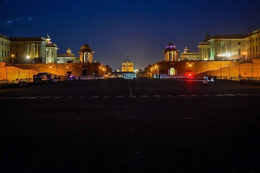 A nighttime view of a grand building with domed structures and classical architecture. 5
