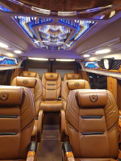 A luxurious train interior with leather seats, a digital control panel, and a decorative ceiling. 3