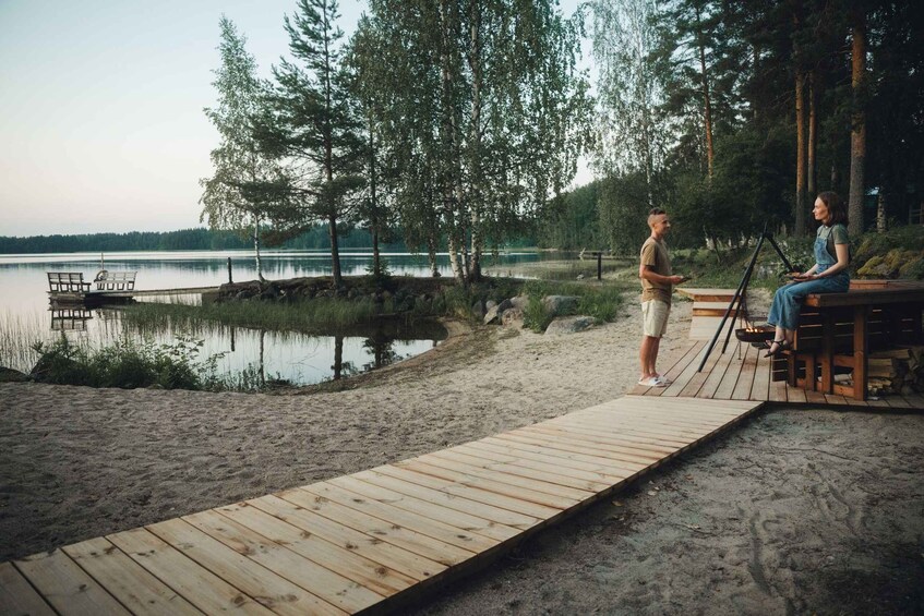 A wooden dock extending into a lake surrounded by trees. 3
