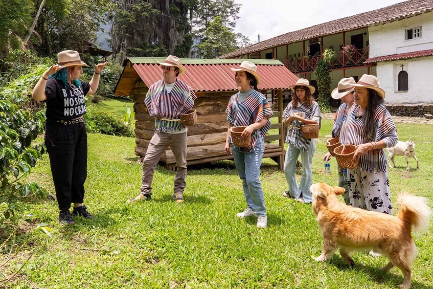 A group of people in a rural setting with a wooden structure and a dog. 4