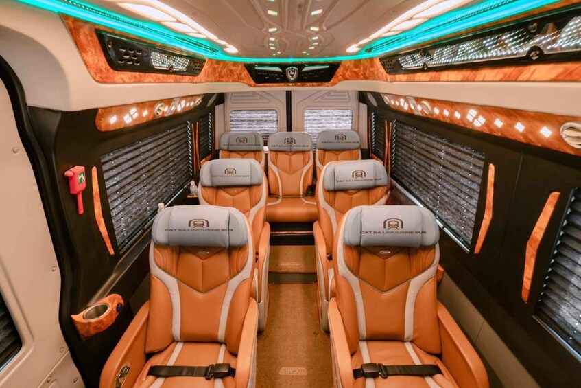 A luxurious interior with orange leather seats, a central aisle, and a modern design. 4