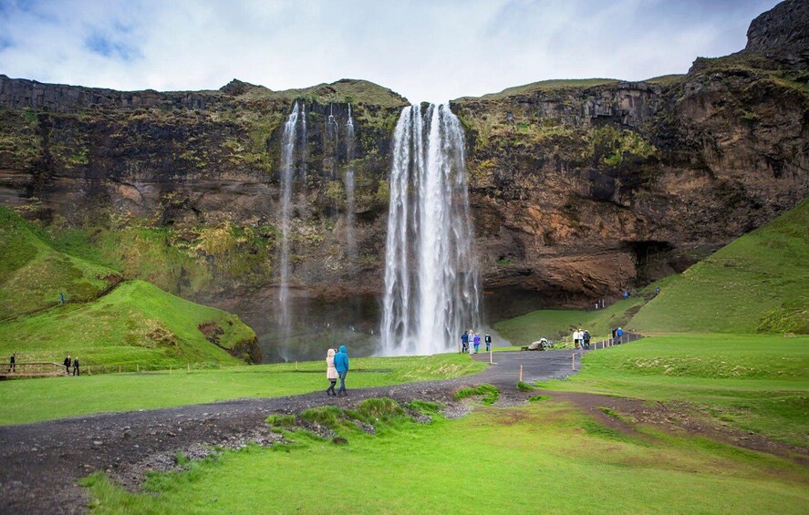 A waterfall with multiple streams cascading down a cliff. 5