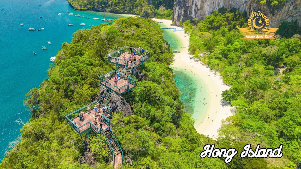 A tropical island with a wooden walkway, clear turquoise waters, and a beach. 5