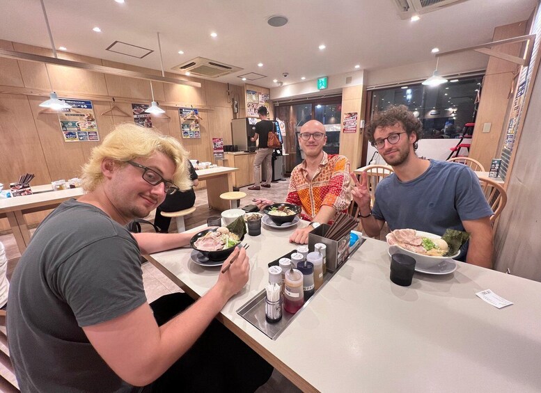 A group of people dining at a restaurant with various dishes on the table. 4
